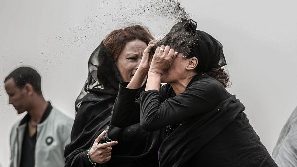 An Ethiopian relative of a crash victim throws dirt in her own face after realising that there is nothing physical left of her loved one. An Ethiopian relative of a crash victim throws dirt in her own face after realising that there is nothing physical left of her loved one.