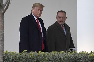 President Donald Trump, left, and acting White House chief of staff Mick Mulvaney, right, walk along the colonnade of the White House in Washington