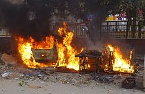 Carts belonging to street vendors go up in flames after clashes in New Delhi
