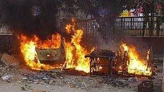 Carts belonging to street vendors go up in flames after clashes in New Delhi