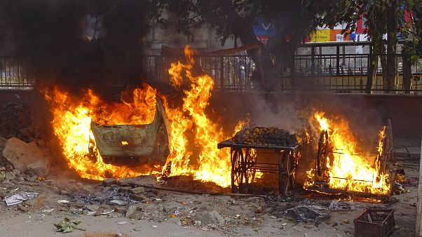Carts belonging to street vendors go up in flames after clashes in New Delhi Carts belonging to street vendors go up in flames after clashes in New Delhi