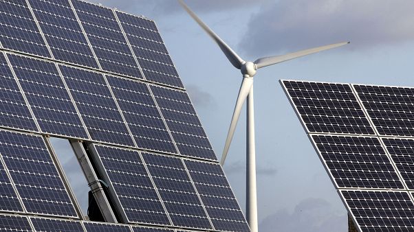 Photovoltaic modules and a windmill are pictured at the village of Feldheim near Berlin, Germany. Photovoltaic modules and a windmill are pictured at the village of Feldheim near Berlin, Germany.