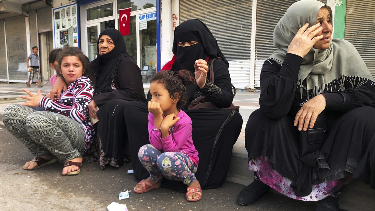 Syrian refugees living in Akcakale, southeastern Turkey, wait for bread distribution by the local municipality