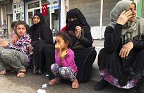 Syrian refugees living in Akcakale, southeastern Turkey, wait for bread distribution by the local municipality