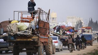 Syrian refugees head northwest through the town of Hazano in Idlib province as the flee renewed fighting Monday, Jan. 27, 2020. 