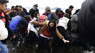 Migrants arrive with a dinghy at the village of Skala Sikaminias, on the Greek island of Lesbos, after crossing the Aegean sea from Turkey, on Friday, Feb. 28