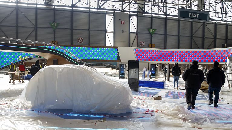 Workers dismantle a booth after that the 90th Geneva International Motor Show is cancelled by Swiss authorities, Friday, Feb. 28, 2020. Workers dismantle a booth after that the 90th Geneva International Motor Show is cancelled by Swiss authorities, Friday, Feb. 28, 2020.