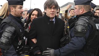 olice surround Catalonia's former regional president Carles Puigdemont as he arrives at the European Parliament in Strasbourg, eastern France, Monday, Jan. 13, 2020.