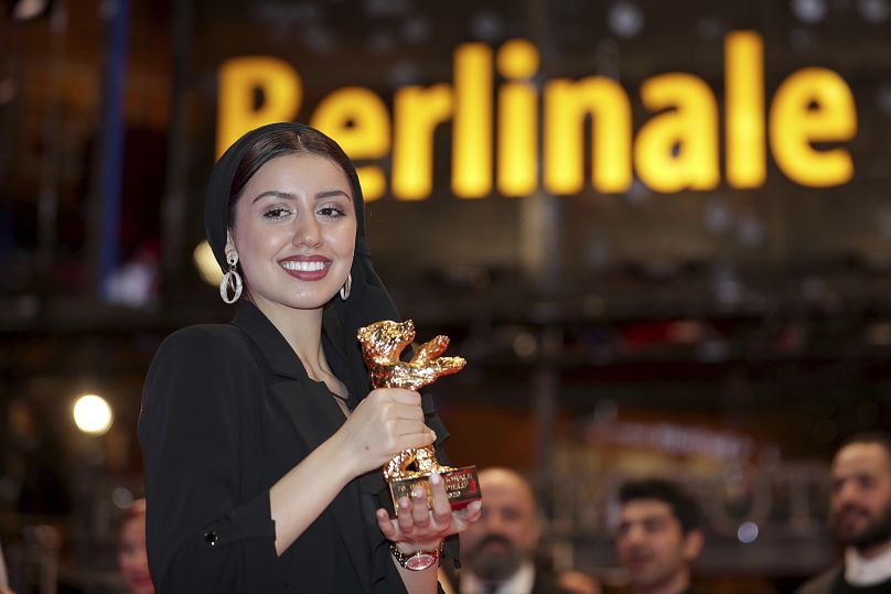 Baran Rasoulof, his daughter, holds the Golden Bear for Best Film in place of Mohammad Rasoulof, who did not attend, for the film 'There Is No Evil' in Berlin 2020