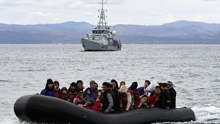 Migrants arrive with a dinghy accompanied by a Frontex vessel at the village of Skala Sikaminias, on the Greek island of Lesbos, after crossing the Aegean sea from Turkey 