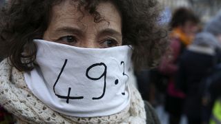 A woman in Marseille protests against the government's use of Article 49.3 of the Constitution to bypass parliament over pension reform.