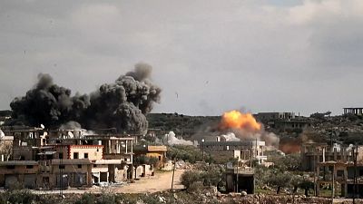 Smoke billows after air strikes hit Syrian towns of Al-Bara and Baylun