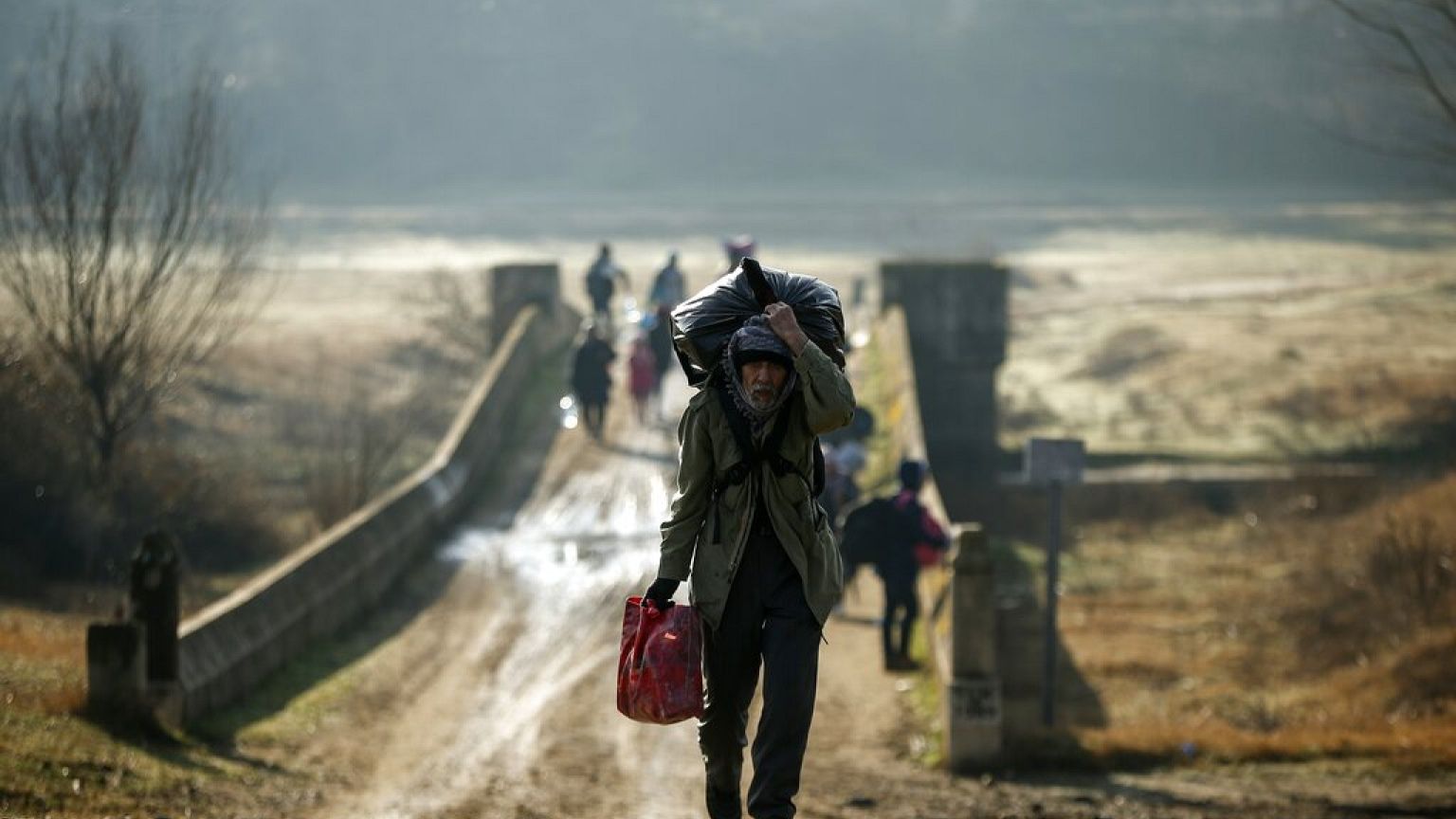Migrants walk to enter Greece from Turkey by crossing the Maritsa river near the Pazarkule border gate in Edirne, Turkey.
