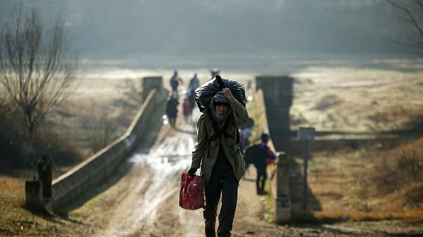Migrants walk to enter Greece from Turkey by crossing the Maritsa river near the Pazarkule border gate in Edirne, Turkey. Migrants walk to enter Greece from Turkey by crossing the Maritsa river near the Pazarkule border gate in Edirne, Turkey.