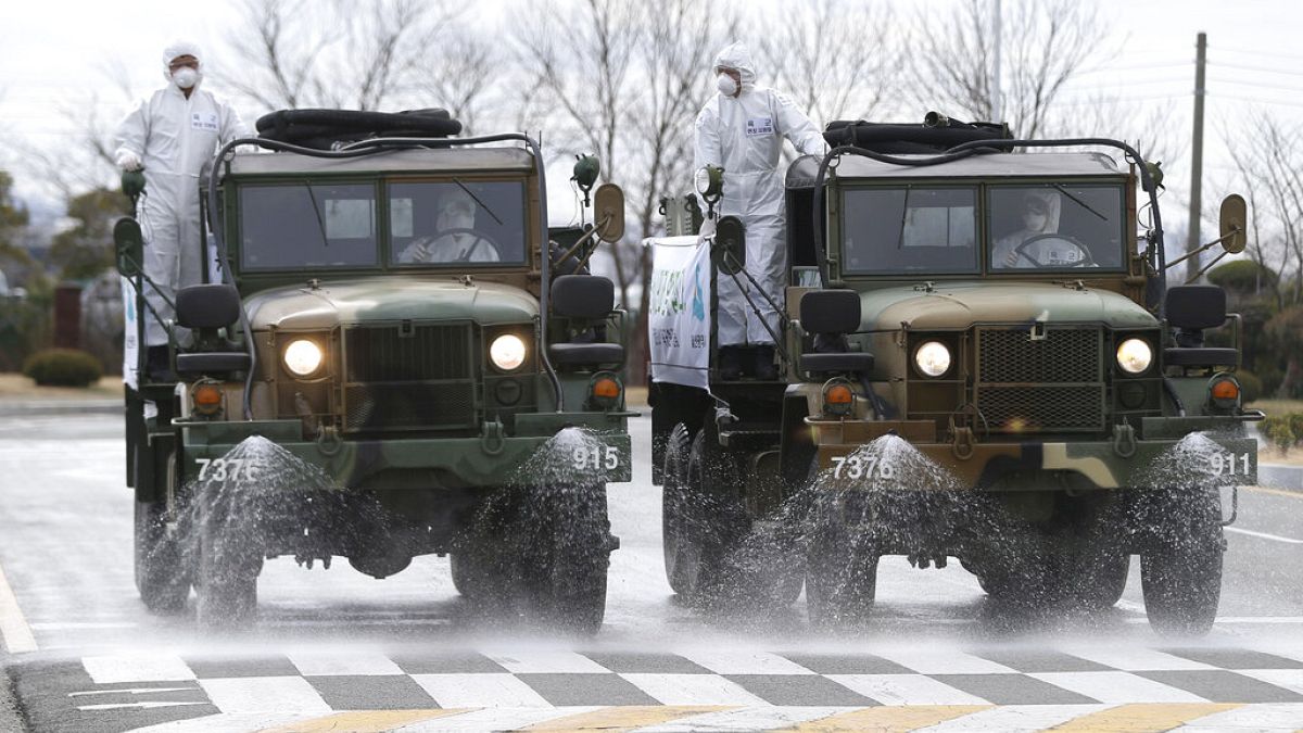 Army trucks spray disinfectant against coronavirus on a street Ulsan, South Korea