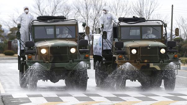 Army trucks spray disinfectant against coronavirus on a street Ulsan, South Korea Army trucks spray disinfectant against coronavirus on a street Ulsan, South Korea