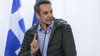 Greek Prime Minister Kyriakos Mitsotakis gestures during a press conference. 