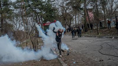 Un migrant renvoie une grenade de gaz lacrymogène à la police grecque à la frontière greco-turque, le 04 mars 2020