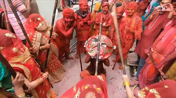 Indians celebrate Holi festival, women 'beat' men with sticks as part of festivities Indians celebrate Holi festival, women 'beat' men with sticks as part of festivities