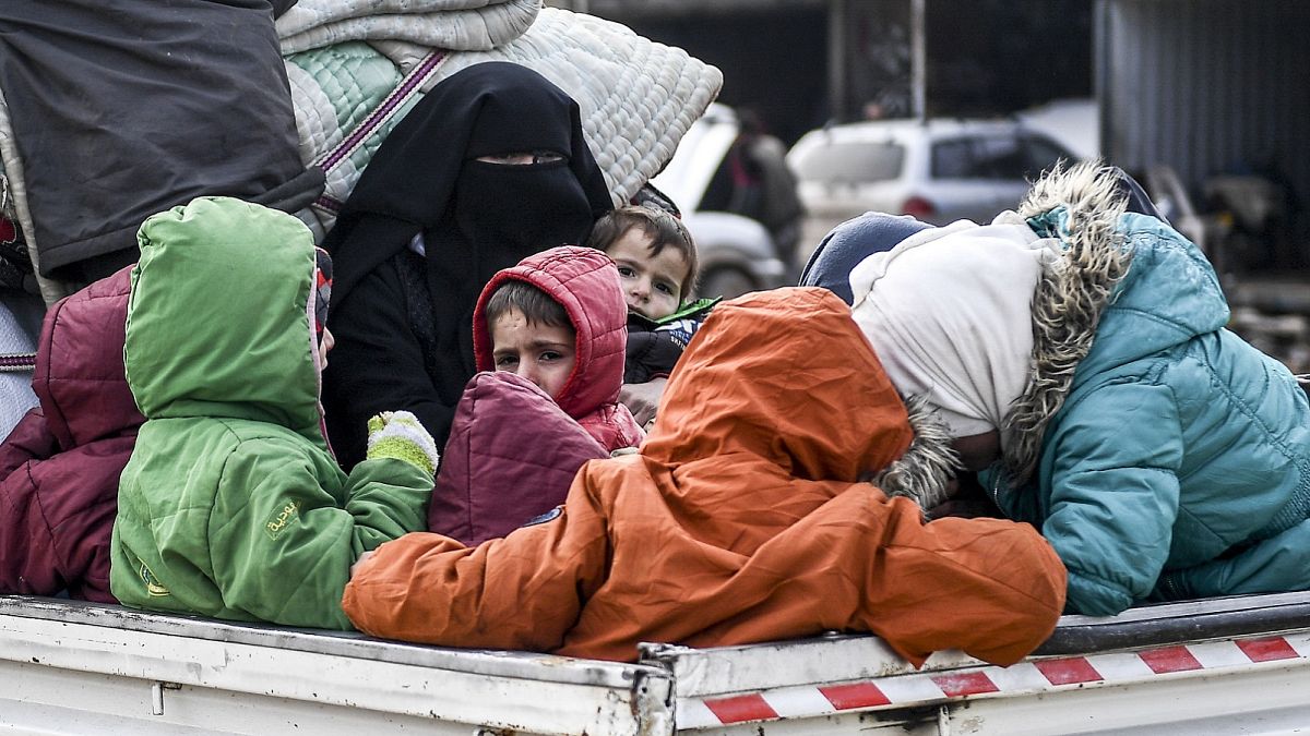 Civilians flee from Idlib toward the north to find safety inside Syria near the border with Turkey, Saturday, Feb. 15, 2020