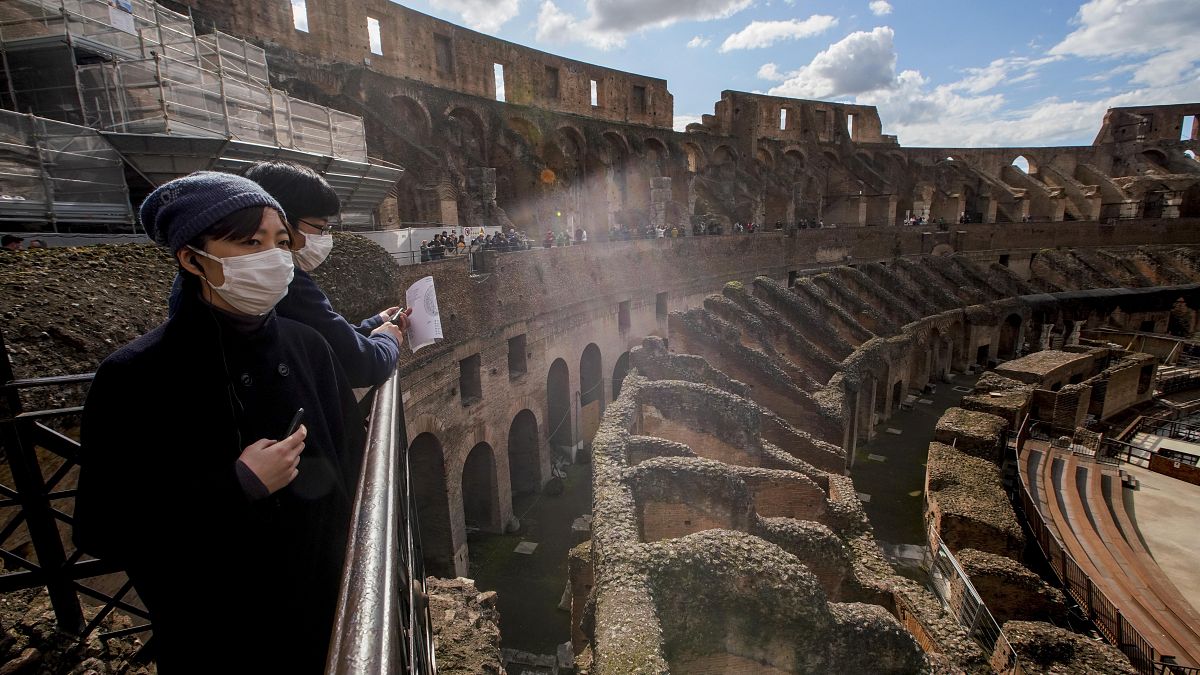 Tourists visit the Colosseum, in Rome, Saturday, March 7, 2020. 