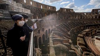 Tourists visit the Colosseum, in Rome, Saturday, March 7, 2020.