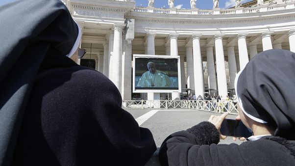 Nuns watch Pope Francis on a giant screen as he delivers the Angelus, in St. Peter's Square, at the Vatican, Sunday, March 8, 2020. Nuns watch Pope Francis on a giant screen as he delivers the Angelus, in St. Peter's Square, at the Vatican, Sunday, March 8, 2020.