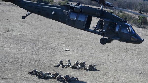 Soldiers of an American unit are dropped by a UH-60 Black Hawk helicopter at a military training center nearby Ujdoeroegd, Hungary, on March 5, 2020. Soldiers of an American unit are dropped by a UH-60 Black Hawk helicopter at a military training center nearby Ujdoeroegd, Hungary, on March 5, 2020.