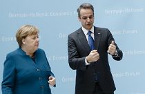 German Chancellor Angela Merkel, left, and the Prime Minister of Greece, Kyriakos Mitsotakis, right
