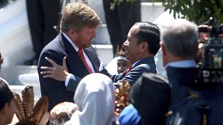 King Willem-Alexander of the Netherlands is welcomed by Indonesian President Joko Widodo on his arrival at the presidential palace in Bogor.
