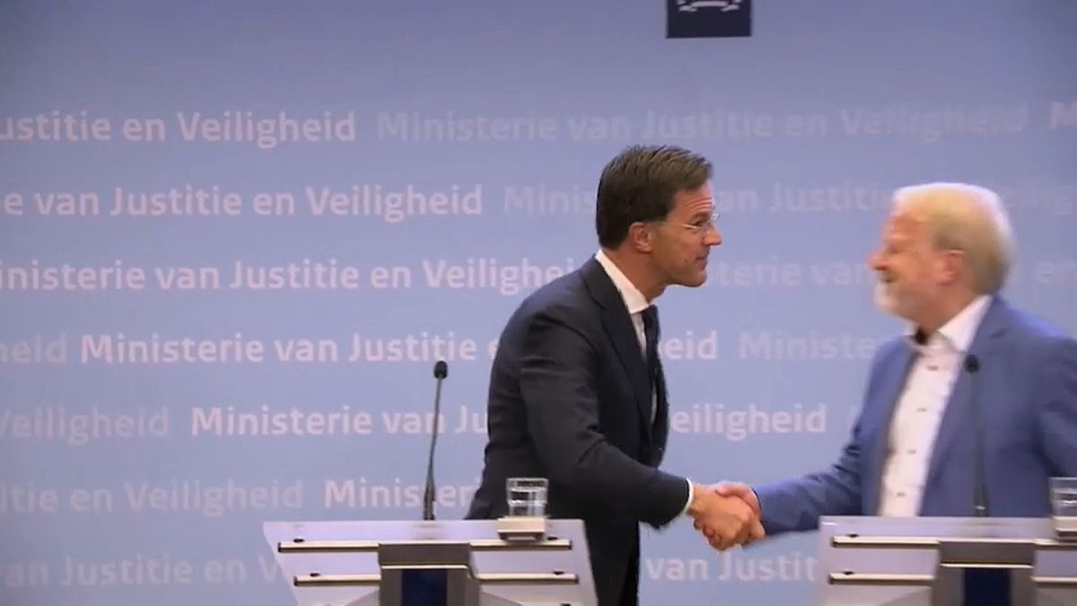 Dutch PM Mark Rutte shakes hands after delivering a speech in which he told citizens to stop handshakes to prevent the spread of COVID-19