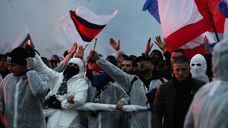 PSG supporters chant as they gather prior a Champions League round of 16 second leg soccer match between Paris-Saint-Germain and Borussia Dortmund at the Parc des Princes stad