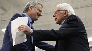 New York Mayor Bill de Blasio greets Democratic presidential candidate Sen. Bernie Sanders, after introducing him at a campaign event in Carson City, Nev.