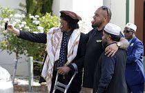 Al Noor mosque attack survivor, Taj Mohammad Kamran, left, takes a selfie with friends outside the Al Noor mosque in Christchurch, New Zealand