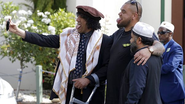 Al Noor mosque attack survivor, Taj Mohammad Kamran, left, takes a selfie with friends outside the Al Noor mosque in Christchurch, New Zealand Al Noor mosque attack survivor, Taj Mohammad Kamran, left, takes a selfie with friends outside the Al Noor mosque in Christchurch, New Zealand