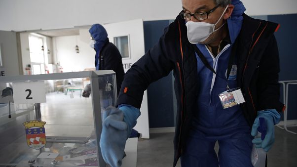 A worker wearing protective gears uses disinfectant to clean a polling box as a precautionary measure against COVID-19 on the eve of the municipal elections. A worker wearing protective gears uses disinfectant to clean a polling box as a precautionary measure against COVID-19 on the eve of the municipal elections.