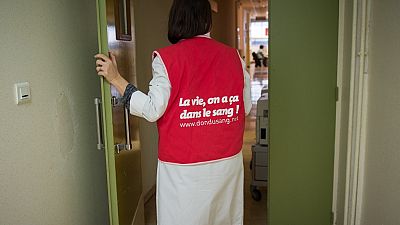 A nurse wearing a jacket on which is written "the life, it's in our blood", Tours, central France. (Photo by GUILLAUME SOUVANT / AFP)