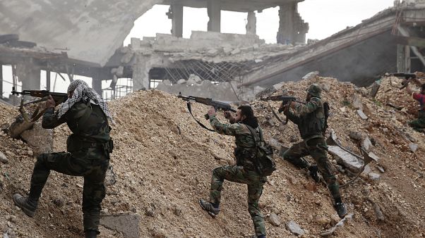 In this Dec. 5, 2016 file photo, Syrian army soldiers fire their weapons during a battle with rebel fighters at the Ramouseh front line, east of Aleppo, Syria. In this Dec. 5, 2016 file photo, Syrian army soldiers fire their weapons during a battle with rebel fighters at the Ramouseh front line, east of Aleppo, Syria.