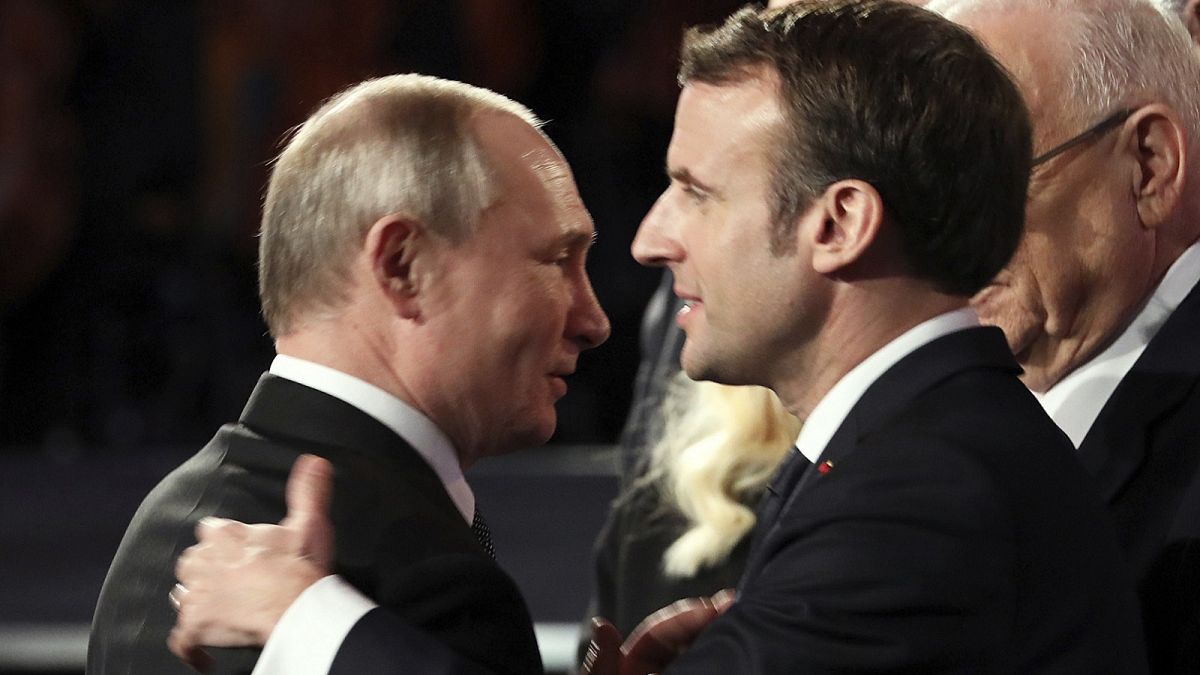 Russian President Vladimir Putin talks with French President Emmanuel Macron during the World Holocaust Forum in Jerusalem, Thursday, Jan. 23, 2020