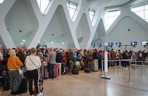 Passengers wait for their flights at the Marrakesh Airport on March 15, 2020