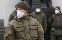 National guard soldiers wearing face masks stand at the parliament building in Kyiv, Ukraine, Tuesday, March 17, 2020. 