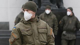 National guard soldiers wearing face masks stand at the parliament building in Kyiv, Ukraine, Tuesday, March 17, 2020.