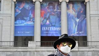 A South Korean tourists wearing a protective face mask walks in front of El Prado museum in Madrid on March 12, 2020