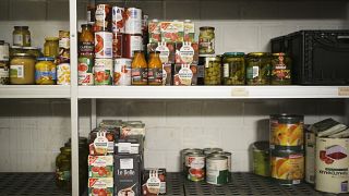 A partially empty shelf storing donated food in a storage room at a food bank in Berlin, Germany, Friday, March 13, 2020.