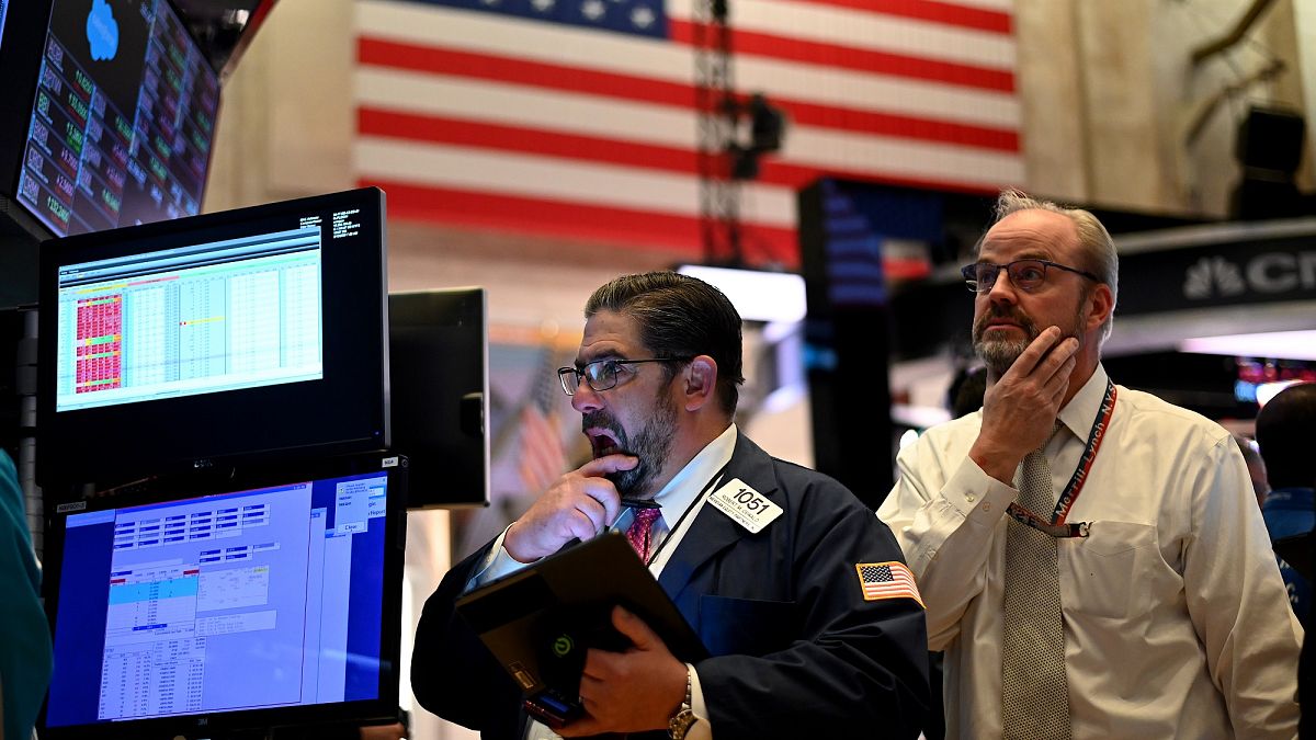 Traders work during the closing bell at the New York Stock Exchange (NYSE) at Wall Street in New York City on March 18, 2020.