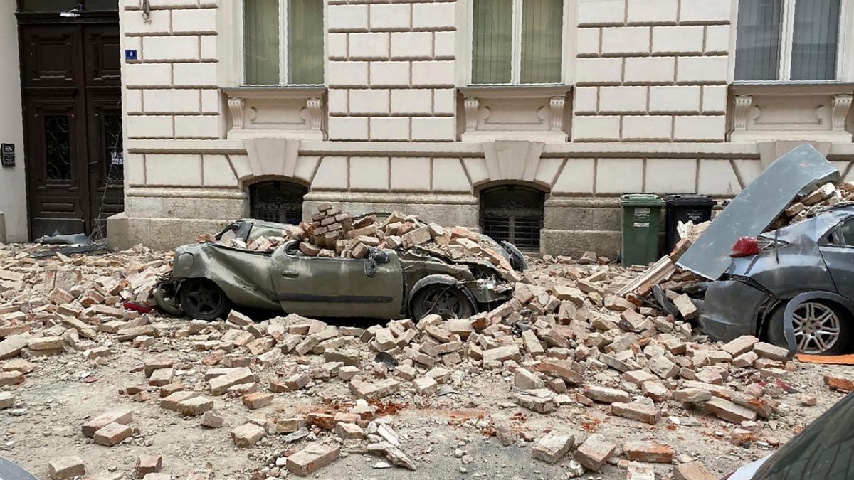 A car is crushed by failing debris after an earthquake in Zagreb, Croatia, Sunday March, 22, 2020.