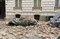 A car is crushed by failing debris after an earthquake in Zagreb, Croatia, Sunday March, 22, 2020.