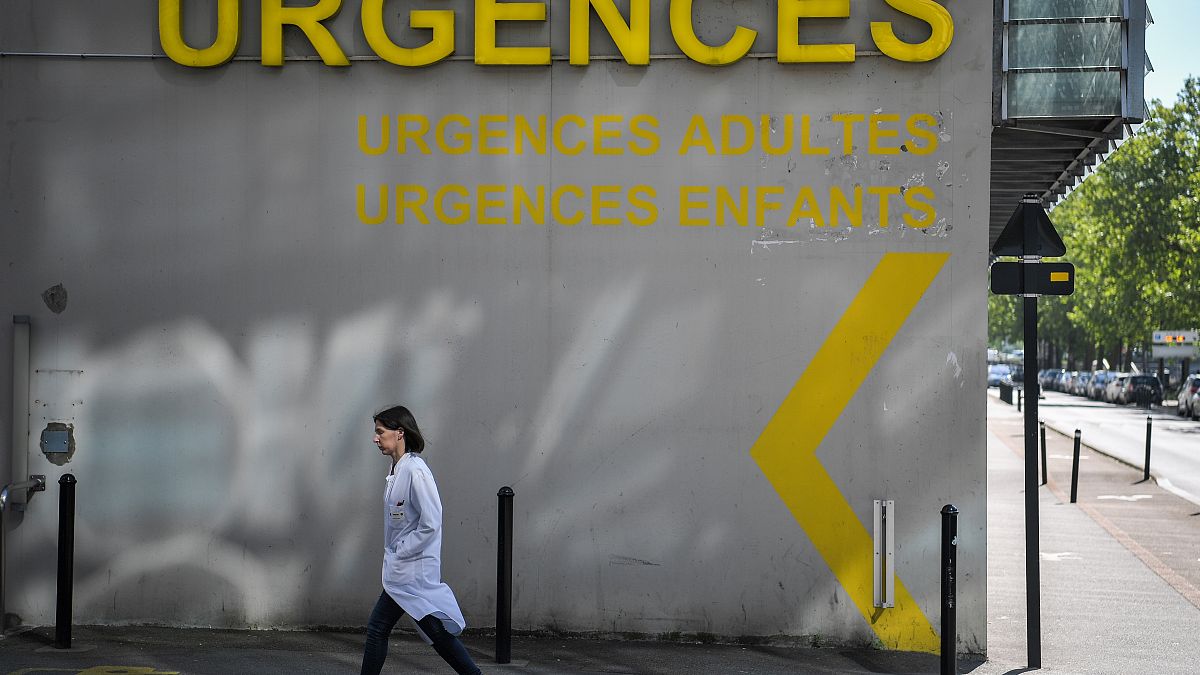 A doctor walks past the entrance of the emergency service of the University Hospital (CHU) in Nantes, western France on April 30, 2019