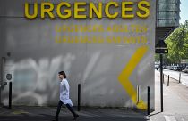 A doctor walks past the entrance of the emergency service of the University Hospital (CHU) in Nantes, western France on April 30, 2019