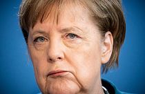 German Chancellor Angela Merkel makes a press statement. (Photo by Michael Kappeler / POOL / AFP)